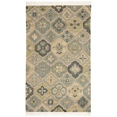 a rug with an abstract design on the side and fringes in blue, beige and green