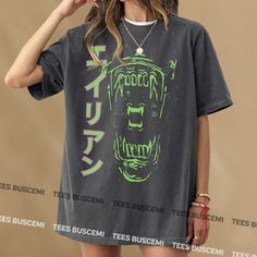 a woman wearing a t - shirt with an image of a monster on it