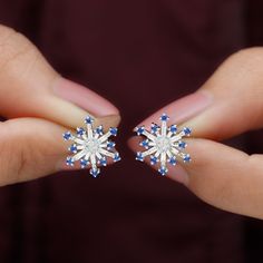 Product Details These Snowflake Stud Earrings is embellished with Round Shaped Lab Created Blue Sapphire with Round and Baguette Shape Diamond in Prong Setting. Product Information SKU SHP-EARRINGS042168834 Weight 2.08 gm (Approximate) LAB CREATED BLUE SAPPHIRE INFORMATION No.of Stones 24 Pieces Total Weight 0.36 Carat (Approximate) Dimension(approx) Round-1.50X1.50 mm-24 Pcs Color Blue Cut Brilliant Shape Round Setting Type Prong-Setting Quality Grade AAAA DIAMOND INFORMATION No.of Stones 26 Pi Snowflake Earrings, Snowflake Design, Back Jewelry, Signature Jewelry, Sapphire Earrings, Everyday Outfit, Christmas Earrings, Pretty Earrings, Sapphire Gemstone