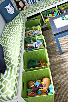 toy bins are organized on the bench in this child's playroom