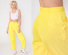 "Vintage 80s pants in bright yellow with a high waist and pleating in the front. Relaxed tapered leg. Please see measurements and condition below. Every garment we sell is authentic vintage! You will receive the exact item photographed. Condition: Very good vintage with light general wear. Best fits women's: Modern extra small Tag: Counterparts Petites Material:  Cotton Polyester blend MEASUREMENTS Taken from seam to seam while the garment is lying flat. Double the armpit, waist, and hips For re 80s Pants, Relaxed Pants, Pants Vintage, Pleated Trousers, Tapered Pants, Bright Yellow, High Waisted Pants, Trousers Women, High Waist