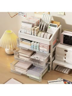 an organized desk with drawers and office supplies