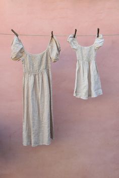 Style // The shade of beige! The Wildflower Dress is designed to be her favorite little girl dress. Featuring an elastic bodice to allow for growth, puffed sleeves, and the cutest square neck line. Available in matching mommy and me outfits for any occasion, it even makes the perfect little flower girl dress! Fabric Note // Hand made in Italy from 100% Linen Sizing Advice // Available in three sizes, we recommend sizing true to age as elastic bodice will allow for flexibility 1-2 Years: Length: Beige Puff Sleeve Dress With Smocked Back, Beige Square Neck Dress With Smocked Back, Beige Ruched Square Neck Dress, Beige Puff Sleeve Dress With Smocked Bodice, Cream Square Neck Dress With Gathered Sleeves, Cream Puff Sleeve Dress With Smocked Back, Beige Smocked Back Square Neck Dress, Beige Smocked Square Neck Dress, Beige Smocked Dress With Square Neck