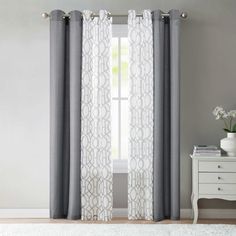 the curtains are hanging in front of a window with white and gray drapes on it