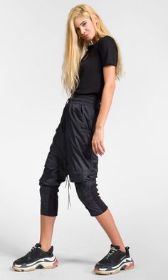 Cropped track pants with knee flap details, made of lightweight polyester fabric for a modern and comfy look. Details: * Elastic waistband with elastic drawstrings and stoppers * Front zipper closure * Decorative knee flaps * Elastic ribbed details * Two front pockets and two back zippered pockets * Calf width adjustment via Velcro patches Black Hooded Coat, Womens Trousers, Velcro Patches, Womens Pants, Cut Out Top, Hooded Coat, Long Sleeve Tunic, Trousers Women, Track Pants