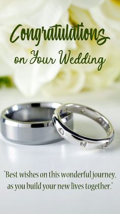 two wedding rings sitting next to each other