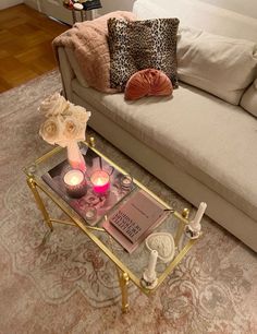 a living room with a couch, coffee table and pillows on it's side