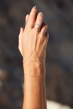 This dainty bracelet has been handcrafted from the highest quality 925 silver and is available in pure silver or gold plated with 24 carat gold. Minimalistic and exquisite, the Sanje bracelet is a timeless piece, suiting any outfit and occasion. Its geometrical shape makes it ever more striking, adding a special touch to anything you wear it with. Here worn with our Ular bracelet. Please note: We recommend adjusting the extension chain around your wrist to your desired length, however making sur Triangle Bracelet, Gold Arm Cuff, Bracelet Minimal, Hand Chain Jewelry, Minimal Bracelet, Bracelet Dainty, Dainty Bracelet, Arm Cuff, Boho Bracelet