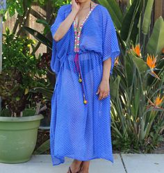 This Tie Dye printed kaftan coverup is perfect for the beach or vacation wear. Semi sheer chiffon fabric moves in the sea breeze. Beautiful embroidery on neck and draw string waist for an easy fit. - handmade -chiffon -machine washable for easy  care  - easy fit drawstring waistband -plus size fits XL-2XL 10-16 Model is 5'6 135 lbs 34C Wears size U.S. 4 Blue V-neck Beach Cover-up, Blue Flowy Cover-up For Beach Season, Blue Bohemian Resort Cover-up, Beachwear Tunic Cover-up For Festivals, Blue Tunic Cover-up For Spring, V-neck Kaftan For Resort Season, V-neck Beachwear Kaftan For Poolside, Summer V-neck Kaftan For Pool, V-neck Kaftan For Poolside And Beach Season