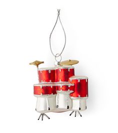 a christmas ornament with red drums hanging from it's sides