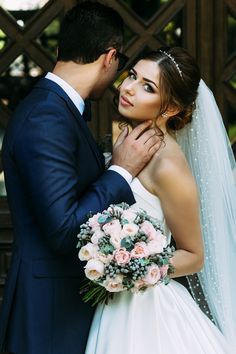 a bride and groom pose for a wedding photo