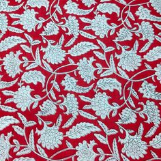 red and white fabric with floral design on the bottom, in very close up view