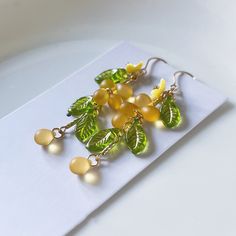 These handmade earrings are crafted with Czech glass grapes, giving them a unique and charming design. The earrings feature a water drop shape, which is both elegant and playful, perfect for adding a touch of sweetness to your look. The earrings are versatile and can be worn for a variety of occasions, from casual outings to special events. The ear clips are comfortable to wear and will securely hold the earrings in place. These earrings are a great gift for anyone who loves handmade jewelry, un Glass Grapes, Plant Earrings, Grape Earrings, Unique Butterfly, Ear Clips, Shell Design, Autumn Beauty, Ear Hook, Water Drop