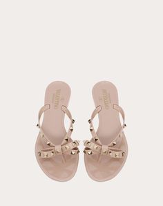 Valentino Garavani PVC sandal. Bow detail with platinum-finish studs - Lace pattern sole - Heel: 5mm / 0.2 in. - Made in Italy Valentino Slippers, Valentino Flats, Luxury Slides, Designer Flip Flops, Rubber Slippers, Valentino Sandals, Luxury Bags Collection, Beads Design, Woman In Black