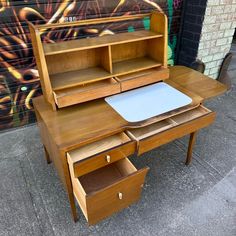 a wooden desk with drawers and a laptop on it