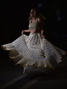 This beautiful ivory butti georgette lehenga with big ruffle detailing is paired with a gotta, mirror and pearl work bustier. This outfit is completed with an ivory sequenced butti work dupatta with a scallop border. Georgette Lehenga, Scallop Border, Pearl Work, Lehenga, Custom Sizing, Victorian Dress, Comfort Fit, Boutique, Mirror