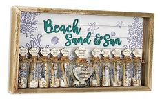 a wooden sign with sand and sea shells on it that says beach, sand & sun