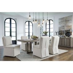 a dining room table with chairs and a bench in front of two large windowed windows