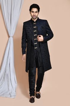 Blue sherwani jacket with all over geometric pattern. Paired with an inner black kurta and churidar. - Aza Fashions Designer Black Sets For Winter, Black Nehru Jacket With Traditional Drape, Designer Traditional Drape Outerwear For Eid, Black Fitted Kurta For Winter, Fitted Black Nehru Jacket For Transitional Season, Winter Black Fitted Kurta, Black Ceremonial Sherwani For Winter, Black Semi-formal Winter Sherwani, Black Traditional Wear For Winter Ceremonial