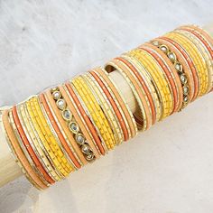 Beautifully designed bangles for any occasion. South asian bracelets come in a variety of styles, colors, and finishes. We at Banglez take creating the perfect bangle set for you to another level! You could say helping you find your favorite stack of bangles as one of our greatest missions. This bangle set was curated in house by one of our talented team members. We hope you love them as much as we do! Traditional Stackable Bangle Cuff Bracelet, Traditional Stackable Bangle For Festive Occasions, Stackable Fusion Style Bangle Bracelets, Adjustable Stacked Bangle Bracelets, Orange Bracelet For Festivals As Gift, Orange Bracelets For Festivals Gift, Orange Bracelets As Festival Gifts, Orange Festival Bracelet As Gift, Traditional Stackable Bangle Bracelets