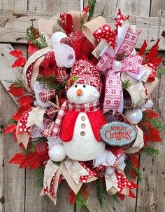 a christmas wreath with a snowman on it