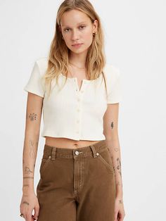 Rachel called and wants her shirt back. All dad jokes aside, the '90s-style Rach Top gives off major throwback vibes while also looking modern af. A slight scoop gives way to buttons down the front, plus it's made from a sweater-like knit. We love it and so will you. A '90s-style cropped top With a slight scoop at the neck Featuring buttons down the front Made with a sweater-like knit Levi's Tops With Button Closure For Summer, Retro Tops For Day Out In Fall, Levi's Tops With Button Closure For Spring, Retro Everyday Fall Tops, 90s Style Relaxed Fit Button-up Top, Everyday Retro Fall Tops, Retro Everyday Tops For Fall, Trendy Levi's Summer Tops, Summer Trendy Levi's Tops