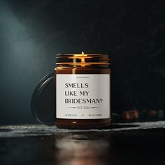 a candle that says smells like my bridesman on it sitting on a table