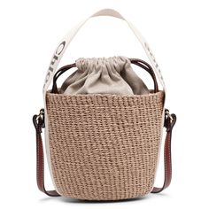 Brown raffia bucket bag with white detailing from Chloé. The Woody tote bag is handwoven from partly upcycled materials by independent craftswomen in Kenya. It features a drawstring fastening and a long leather strap for shoulder and crossbody wear. It is complete with an embroidered Chloé logo for graphic contrast and signature touch.Measurements: L17 x H16 x W16cmMade in Italy Raffia Bucket Bag, Chloe Logo, Upcycled Materials, Kenya, Bucket Bag, Leather Straps, Chloe, Hand Weaving, Tote Bag