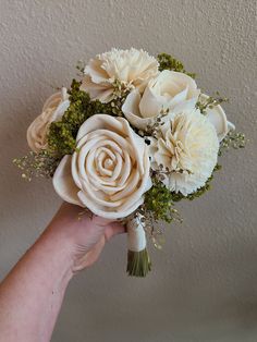 a person holding a bouquet of flowers in their hand