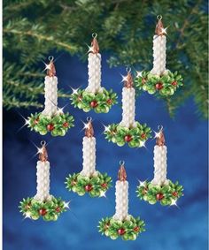 six christmas candles hanging from a tree