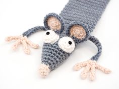 a crocheted mouse head on top of a gray and white knitted tie