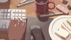 a computer keyboard sitting on top of a wooden desk next to a cup of coffee