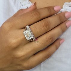 a woman's hand with a ring on it and a diamond in the middle