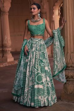 Dark green lehenga with a separate cancan, sequins embroidered waistband and thikri, grid and floral print. Comes with a mirror work padded blouse and a dupatta. - Aza Fashions Green Lehenga With Unstitched Blouse For Navratri, Green Bollywood Style Choli For Designer Wear, Green Bollywood Lehenga With Unstitched Blouse, Unstitched Bollywood Choli In Green, Green Cutdana Choli For Navratri, Designer Green Lehenga With Unstitched Blouse, Green Mirror Work Sets For Reception, Green Bollywood Style Floor-length Choli, Green Sets With Mirror Work For Reception