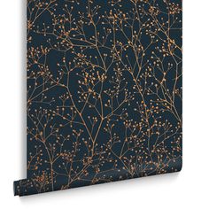 a black and gold wallpaper with small branches on the front, against a dark blue background