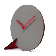 a clock with red hands and an arrow on the side, sitting in front of a white background