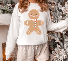 The perfect man does exist! Our cute and cozy retro gingerbread man Sweatshirt is perfect for the holiday season. It's perfect for baking cookies, holiday parties, Christmas lights or just curled up in front of the fireplace watching Christmas movies. This gingerbread man will keep you cozy all winter long.  Christmas Gingerbread Sweatshirt, Christmas Shirt, Cute Christmas Sweater, Retro Holiday Shirt, Christmas sweatshirt, Gingerbread Man, gifts A sturdy and warm sweatshirt bound to keep you wa Gingerbread Sweatshirt, Gingerbread Sweater, Cookies Holiday, Cute Christmas Sweater, Man Gifts, Watch Christmas Movies, Retro Holiday, Baking Cookies, Men Sweatshirt