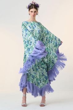 Blue kaftan with all over floral bloom print.
Components: 1
Pattern: Print
Type Of Work: Floral
Neckline: Boat Neck
Sleeve Type: Cape Sleeves
Fabric: Satin
Color: Blue
Other Details: 
Silk fringes all over hemline
Note: The belt worn by the model is not for sale
Occasion: Resort - Aza Fashions Bohemian Floral Print Floor-length Kaftan, Bohemian Floor-length Floral Print Kaftan, Spring Kaftan With Tassels And Kimono Sleeves, Bohemian Floor-length Kimono For Spring, Spring Bohemian Floor-length Kimono, Bohemian Floor-length Spring Kimono, Spring Silk Kaftan With Kimono Sleeves, Spring Multicolor Floral Print Kaftan, Silk Floral Print Floor-length Kaftan