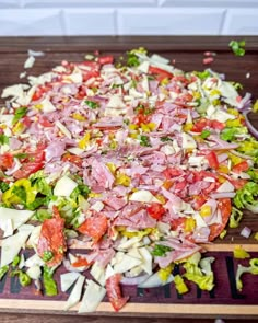 a wooden cutting board topped with chopped up vegetables