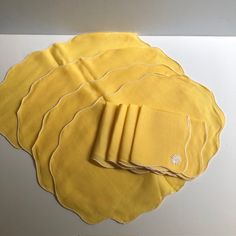 four yellow placemats on top of each other