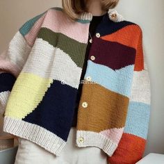 a woman wearing a multicolored cardigan sweater