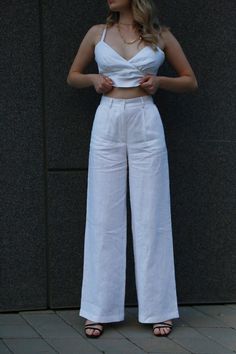 White linen palazzo pants are the epitome of style and comfort, perfect for the warmer seasons. Cut: These pants have a wide, loose cut that allows for maximum freedom of movement and impressive lightness. From the hips to the bottom, the trousers gradually widen, creating an elegant silhouette that emphasizes the slenderness of the figure. Material: Made from high-quality linen, these pants are not only breathable, but also have a nice texture for all-day comfort. Flax also gives the product a natural shine that adds elegance to it. Details: White palazzo pants are easy to match with a variety of tops, from classic blouses and tops to loose t-shirts. They have delicate side pockets that add convenience when wearing. Style: These pants are great for a variety of occasions, from casual outi Chic Linen Wide Leg Pants With Loosely Fitted Hips, Chic Wide Leg Linen Pants, High Waist Linen Wide Leg Pants For Summer, Wide-leg Linen Pants, Linen Wide-leg Pants, White High-waist Linen Wide Leg Pants, High-waisted White Linen Wide Leg Pants, White High Waist Linen Wide Leg Pants, High Waist Linen Wide Leg Pants