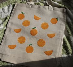 Orange tote bag made of 12oz. 100% Certified Organic Chemical Free Canvas Fabric. Design on bag is made from high quality, direct to transfer print. CARE INSTRUCTIONS:  - Handwash bag inside out in cold water.   - Air dry flat.   - Do not iron directly on the design. Orange Tote Bags, Painted Tote, Free Canvas, Bag Inside, Bag Ideas, Orange Bag, Bag Canvas, Orange Slices, Chemical Free