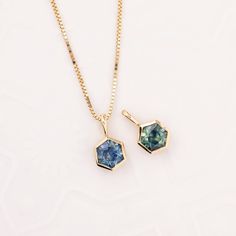 * Choose between 2 different charms or necklaces : * Blue 0.74ct Montana Sapphire, 5.06x5.05x3.22mm, vs1 clarity, Heated * Parti Blue Green Yellow 0.77ct Montana Sapphire, 5.07x5.08x3.37mm, vs1 clarity, * Option of adding an 18" fixed length box chain with spring ring clasp * In stock & ready to ship * Charm size: approx. 11x6mm (excluding bail) * Genuine sapphire, not synthetic, not lab created * Bail Inner Dimension: approx. 3.3x2mm * Ethically sourced solid 14k gold and gemstone * Packaged in Sapphire Pendant Necklace With Natural Stones, Teal Sapphire Necklace Dainty, Sapphire Pendant Necklace With Polished Finish, Green Sapphire Necklace, Montana Sapphire Jewelry, Simple Charm Necklace, Montana Sapphire Necklace, Montana Sapphire, Sapphire Necklace