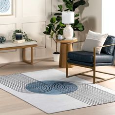 a living room with two chairs and a rug on the floor in front of it