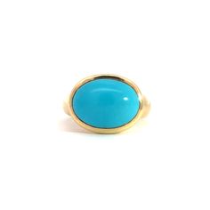 Elevate your style with the stunning Large Oval Cabochon Gumdrop Ring, a true statement piece crafted from luxurious 18K gold. This eye-catching ring features a magnificent 5.44-carat oval cabochon gemstone that radiates with vibrant color and unparalleled clarity.The smooth, polished surface of the cabochon is perfectly complemented by the rich, gleaming gold band, creating a harmonious blend of sophistication and bold elegance. The gumdrop setting adds a playful touch to this timeless design, ensuring the gemstone remains the star of the show while providing a secure and stylish fit.Whether you're dressing up for a special occasion or looking to add a pop of color to your everyday ensemble, the Large Oval Cabochon Gumdrop Ring is sure to turn heads and spark conversations. Slip it on and Luxury Turquoise 14k Gold Ring, Gold Oval Hallmarked Turquoise Ring, Fine Jewelry Hallmarked Yellow Gold Turquoise Ring, Luxury Turquoise Cabochon Ring In Yellow Gold, Fine Jewelry Hallmarked Turquoise Ring In Yellow Gold, Fine Jewelry Turquoise Ring In Yellow Gold, Gold Ring With Large Oval Cabochon Stone, Luxury Yellow Gold Turquoise Cabochon Ring, Luxury Oval Turquoise Gemstone Ring