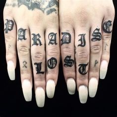 two fingers with tattoos on them are shown