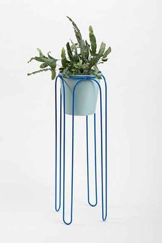 a blue plant stand with plants in it