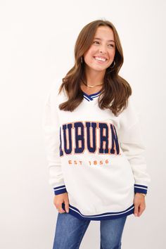 Experience the nostalgia of game days with this Auburn vintage inspired sweatshirt. Featuring varsity stripes and a large chenille logo, this oversized V-neck sweatshirt is perfect for showing off your Tiger pride. Stay cozy and stylish in this classic piece. War Eagle! Women's Auburn pullover Women's Auburn vintage pullover Oversized fit Long length Varsity stripe details Large Auburn chenille logo front Fall Loungewear, Vintage Pullover, Vintage Pullovers, Oversized Pullover, Short Leggings, Stay Cozy, Shop Swimwear, Women Pullover, Auburn