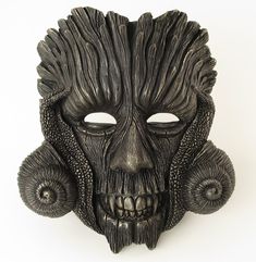 This unique and stunning mask, individually sculpted and handpainted, looks great on a wall and can be worn for parties.  The creation of this mask was inspired by the character of Green Man and His mysterious dark night aspect. This one-of-a-kind original art piece, which you can wear on various occasions or simply display it as a striking and eye-catching home ornament, is made of mixed resin and talc as well as fiberglass cloth. It was created through a complex process, which started with modelling the mask in Plasticine modelling clay and producing a handmade silicone mold. Later it was painted by hand with high quality artistic acrylic paints - black and metallic - and fine tip paint brushes. Height: 22 cm/ 8.7 in Width: 20 cm/ 7.9 in Depth: 11 cm/ 4.3 in Weight: 403 g/ 14.2 oz Fantasy Masks And Prosthetics For Events, Artistic Masks For Halloween Costume Party, Artistic Halloween Mask For Costume Party, Artistic Halloween Masks For Fantasy Events, Artistic Masks For Halloween Masquerade, Artistic Masks For Masquerade And Halloween, Artistic Halloween Masquerade Masks, Artistic Halloween Masks For Theater, Artistic Masks For Theater And Halloween